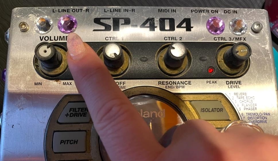 Services & Rates A finger pointing to bump dots on a Roland SP404 sampler
